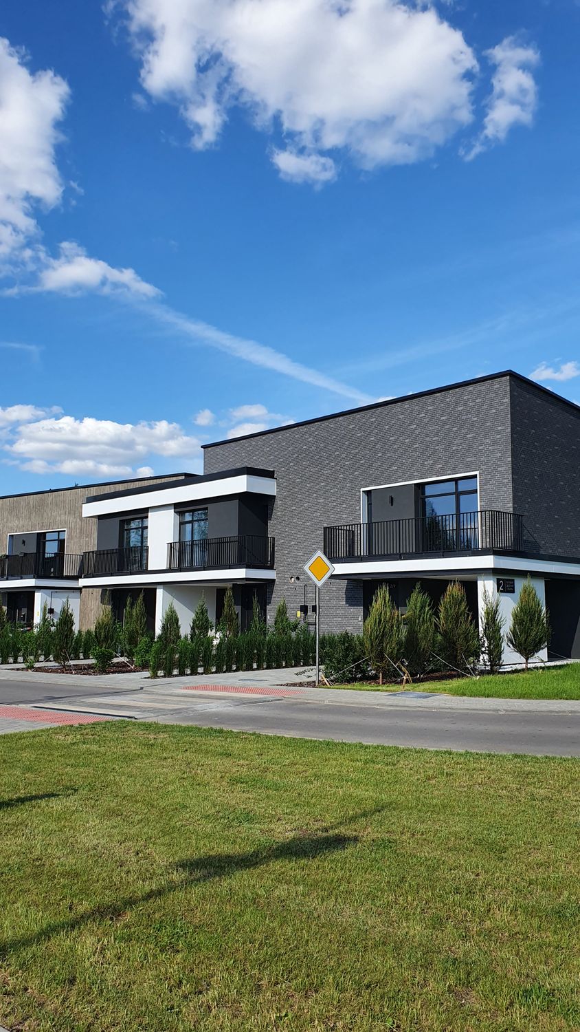 Contemporary homes under a clear blue sky in Minsk, Belarus.