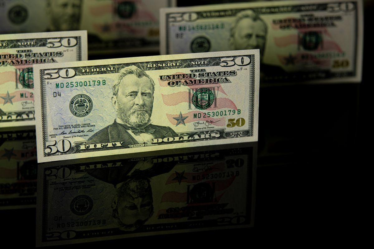 Student Loan Borrowers Hit With Payment Shock After $50 Monthly Bill Error. 1 Crisp 50 dollar bill with reflection, offering a detailed view perfect for financial themes.