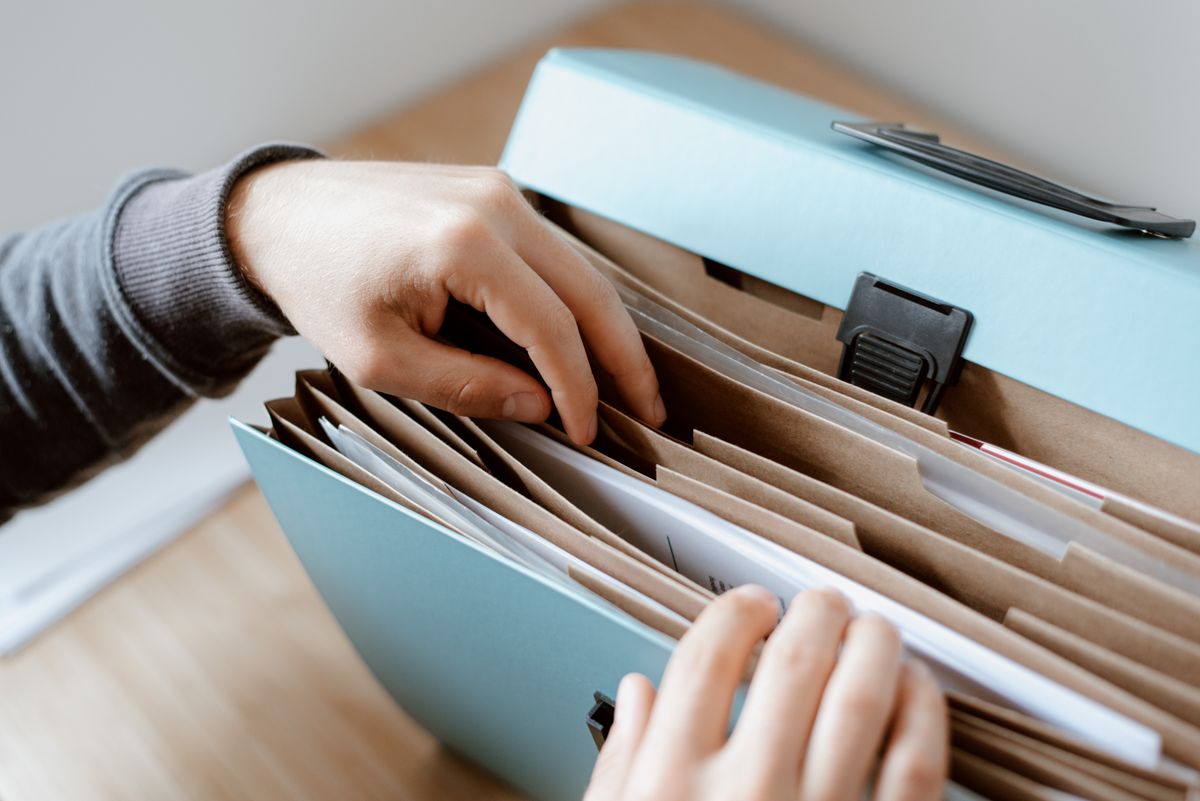 New York’s SantaCon Fraud Case Leaves a Bitter Question for Bars, Donors, and Holiday Crowds 1 Crop unrecognizable person selecting document in opened briefcase for documents placed on wooden table