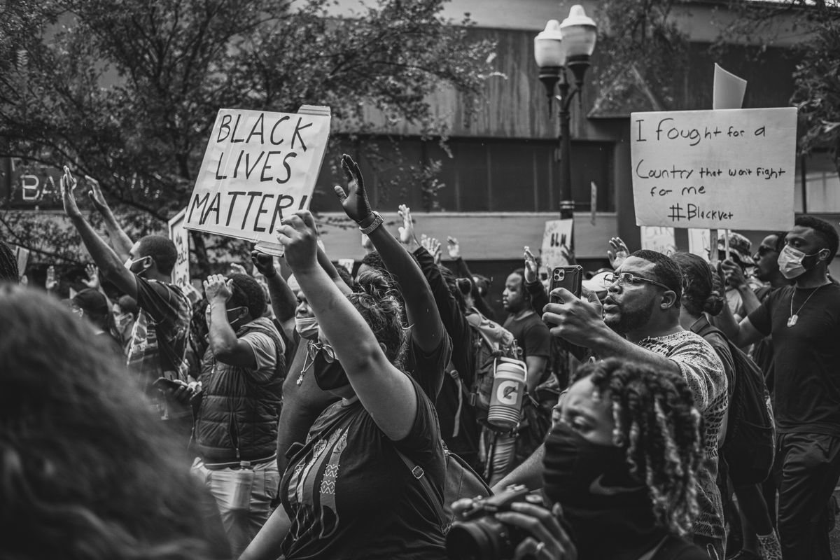 Crowd of people holding signs and protesting for Black Lives Matter.