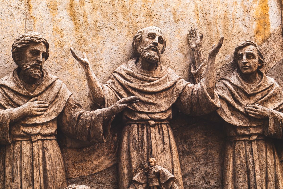 Detailed stone sculpture of monks in prayer, reflecting Renaissance artistry.