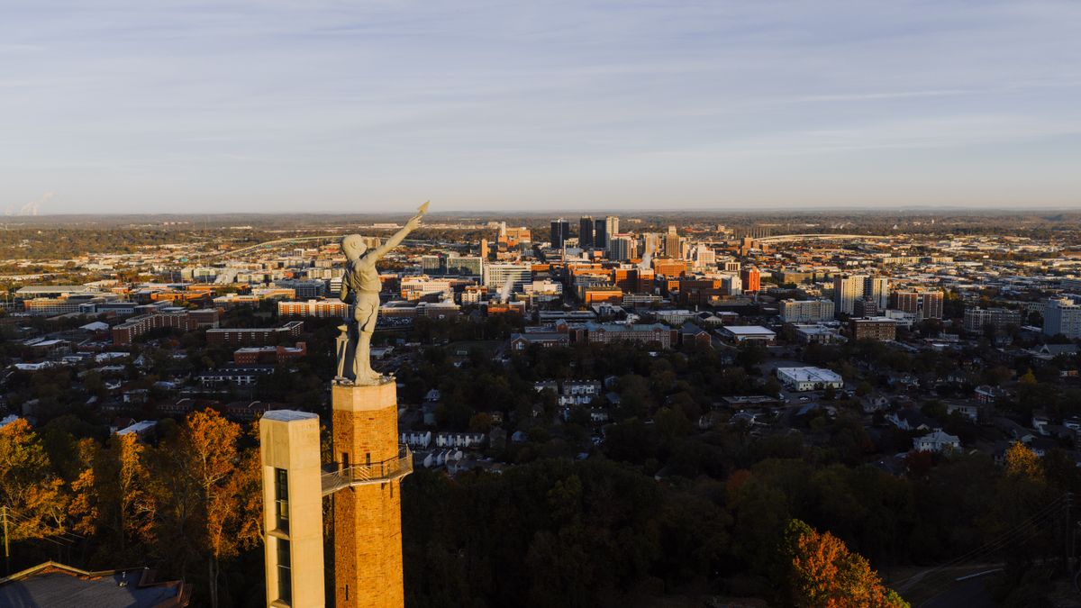 10 Worst States To Live In 2026: Inside America’s Lowest-Ranked Places for Affordability, Safety, and Quality of Life 1 Drone capture of the Vulcan statue with Birmingham city skyline at sunset, Alabama.