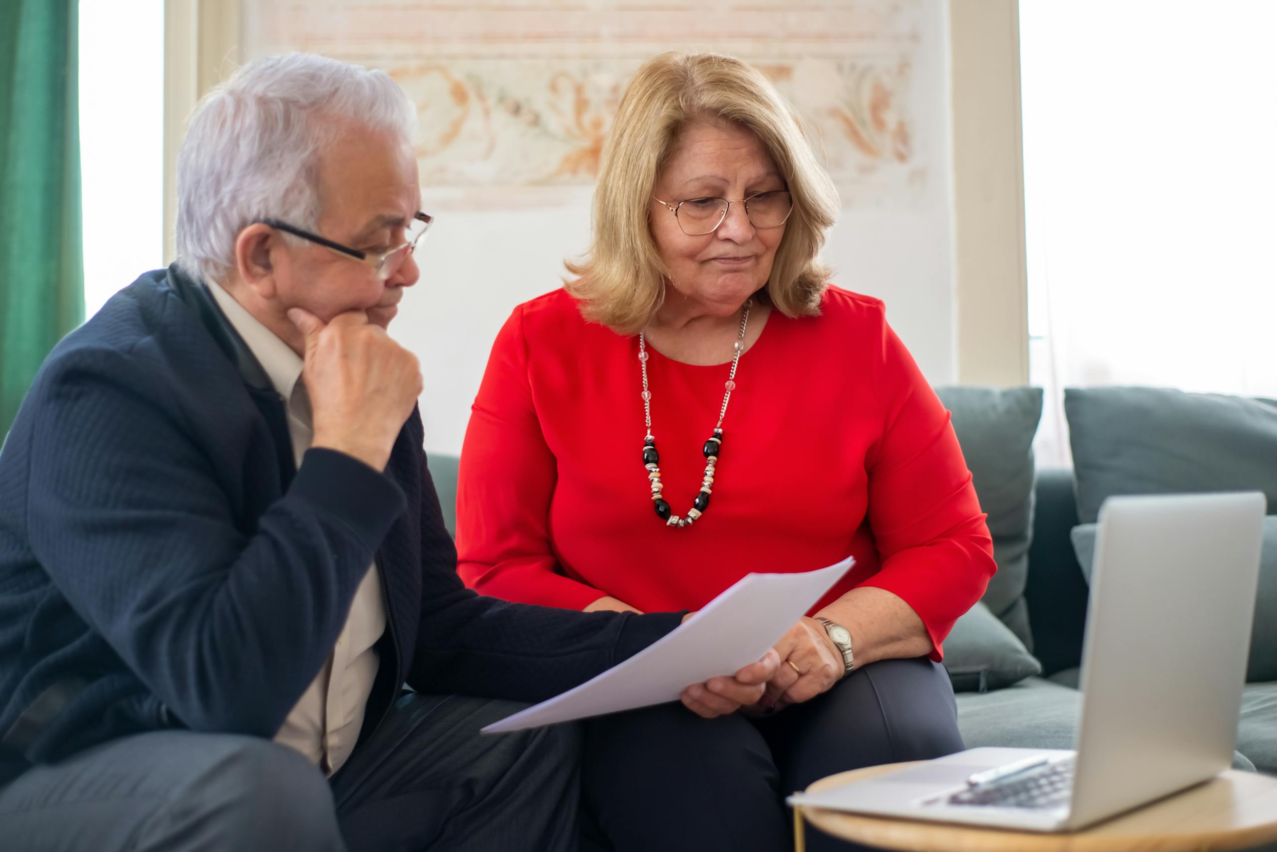 President Trump’s Poll Numbers Drop as Wallet Pain Spreads Across America 1 Elderly couple reviewing financial documents together at home in Portugal.