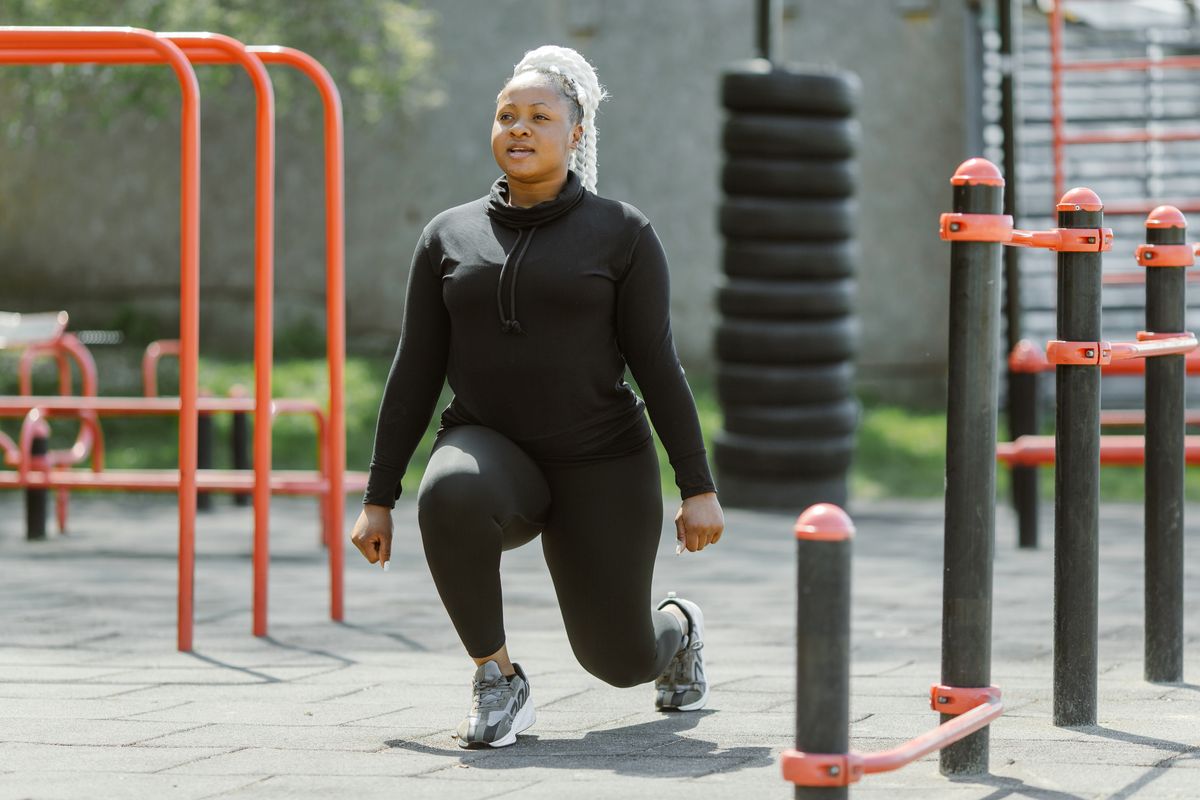 You’re Slowly Ruining Your Life by Ignoring These 9 Lifestyle Habits 1 Fit woman performing lunges at an outdoor gym, embracing a healthy lifestyle.