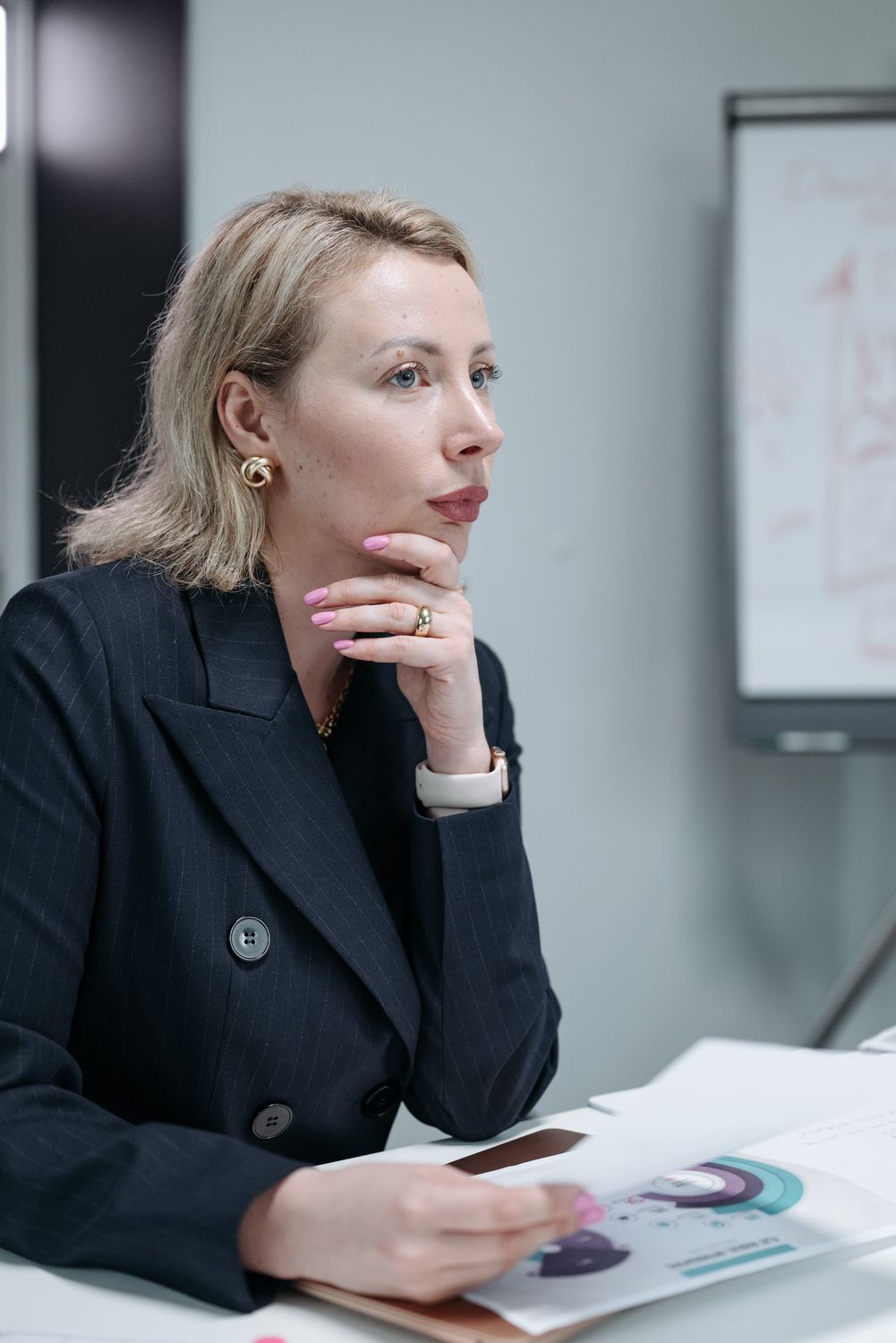 10 Job Skills You’re Ignoring That Are Killing Your Career 3 Focused businesswoman in corporate attire during a meeting, deep in thought.
