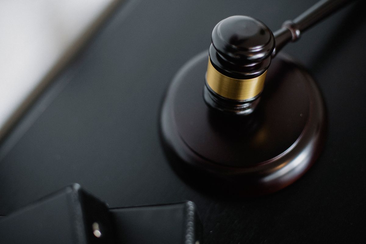 7 States Now Face a New Voting Rights Reality After Supreme Court Decision 3 From above of wooden gavel on round surface near folders on table in courtroom