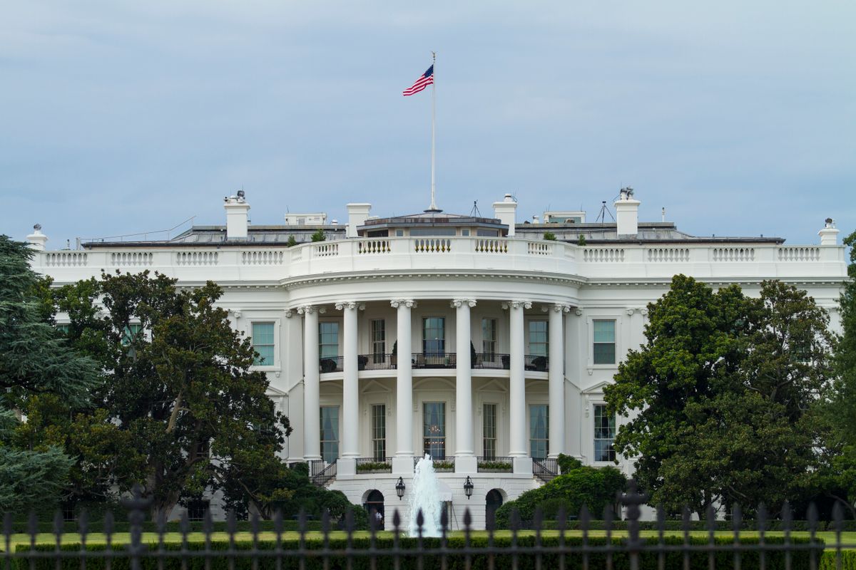 Senate Iran war powers vote exposes a widening constitutional clash with Trump. 2 Front view of the iconic White House with the American flag, surrounded by greenery.