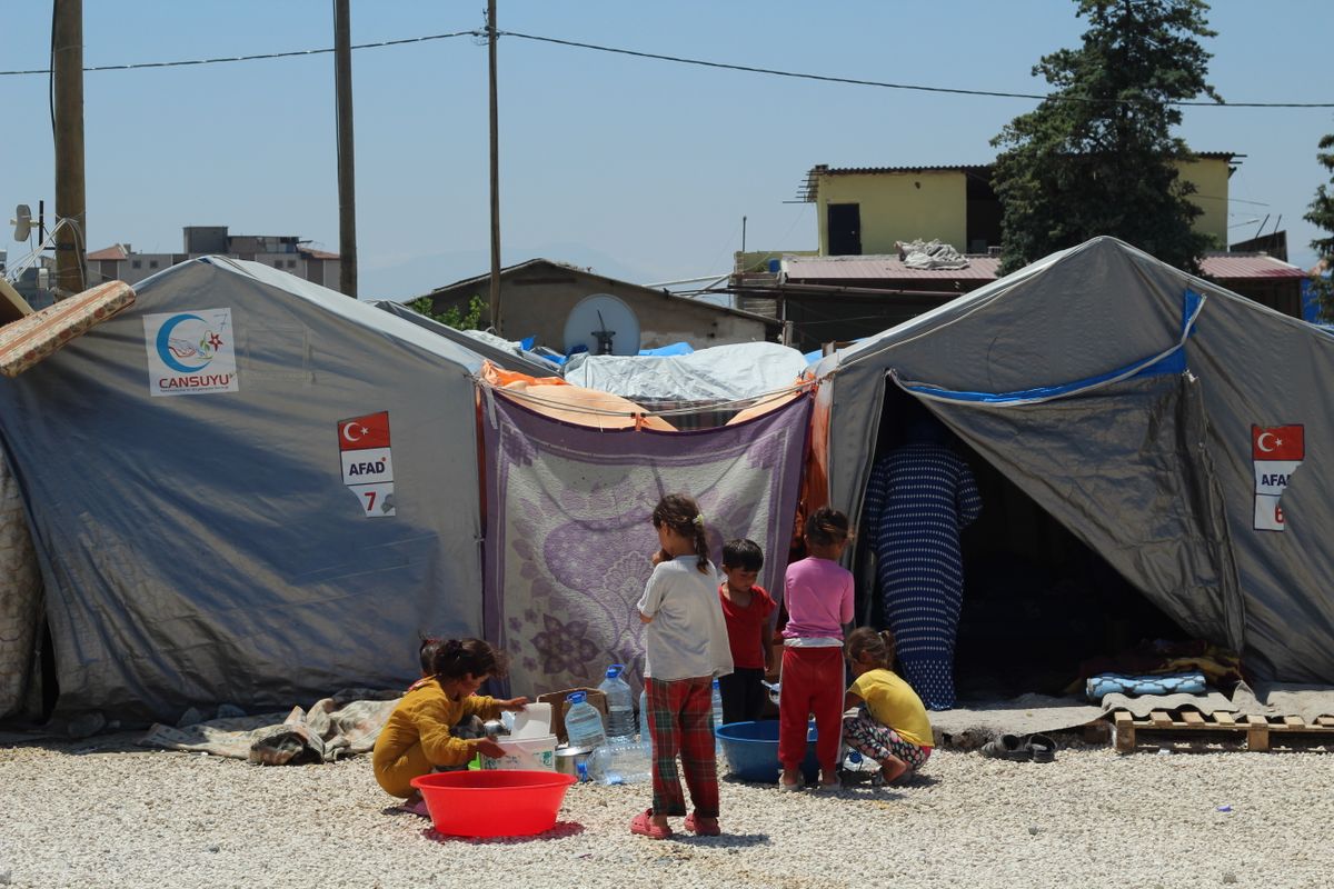 Over 100 Venezuelans Deported From the U.S. Are Missing After Deadly Earthquakes 4 Group of children at a temporary tent camp highlighting post-disaster resilience.