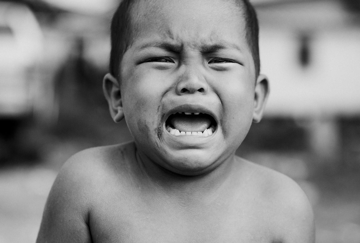 Florida’s Child Hunger Crisis Explodes in 2026: Over 800,000 Kids at Risk 3 Heartfelt portrait of a young child crying, showcasing raw emotion in black and white.