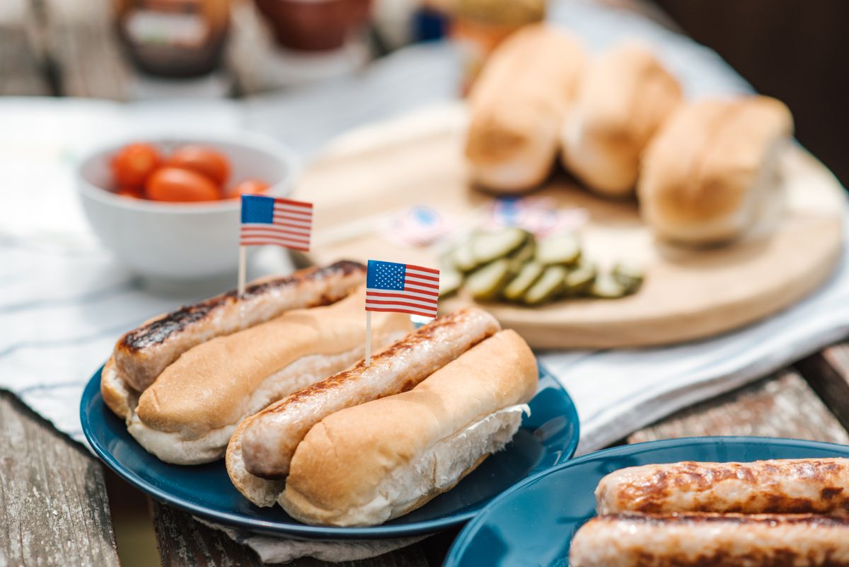 NYC and New Jersey’s Ultimate Food Scene: Where Every Bite Tells a Story 1 Hot dogs with American flags on a plate, perfect for a Fourth of July celebration.