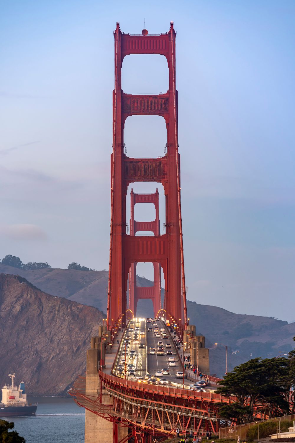Bridges in the USA Aren’t as Safe or Simple as They Seem 1 Iconic view of the Golden Gate Bridge at dusk with flowing traffic, showcasing its grandeur.