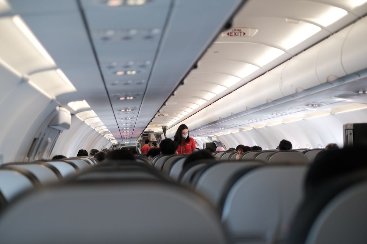 U.S. State Department Issues Global Travel Warnings as Risks Vary Widely Across Countries 1 Passengers and flight attendant inside a Vietnam commercial aircraft. Travel safety with masks.