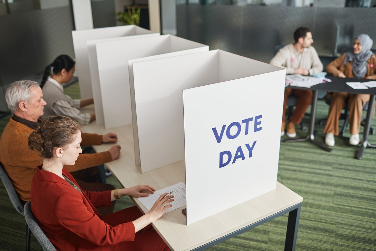 Trump Claims “Real Polling Numbers” Show Different Picture, but Provides No Evidence 1 People casting votes in a polling station on election day, emphasizing civic engagement.