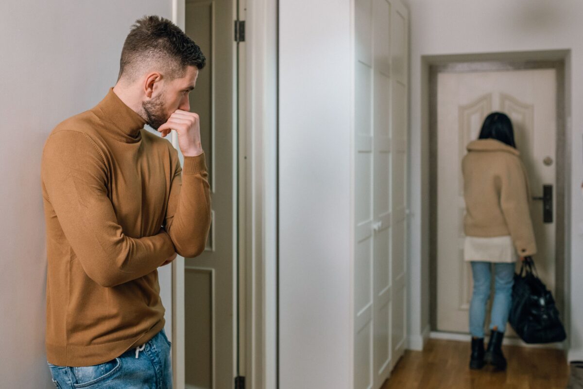 man-looking-at-a-woman-walking-out-of-the-apartment