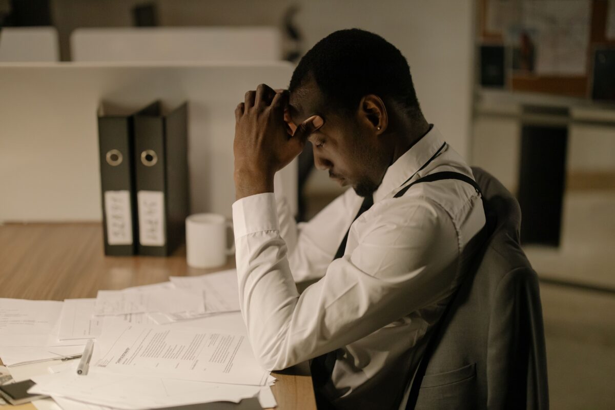 man-staying-up-late-in-office-working-on-papers