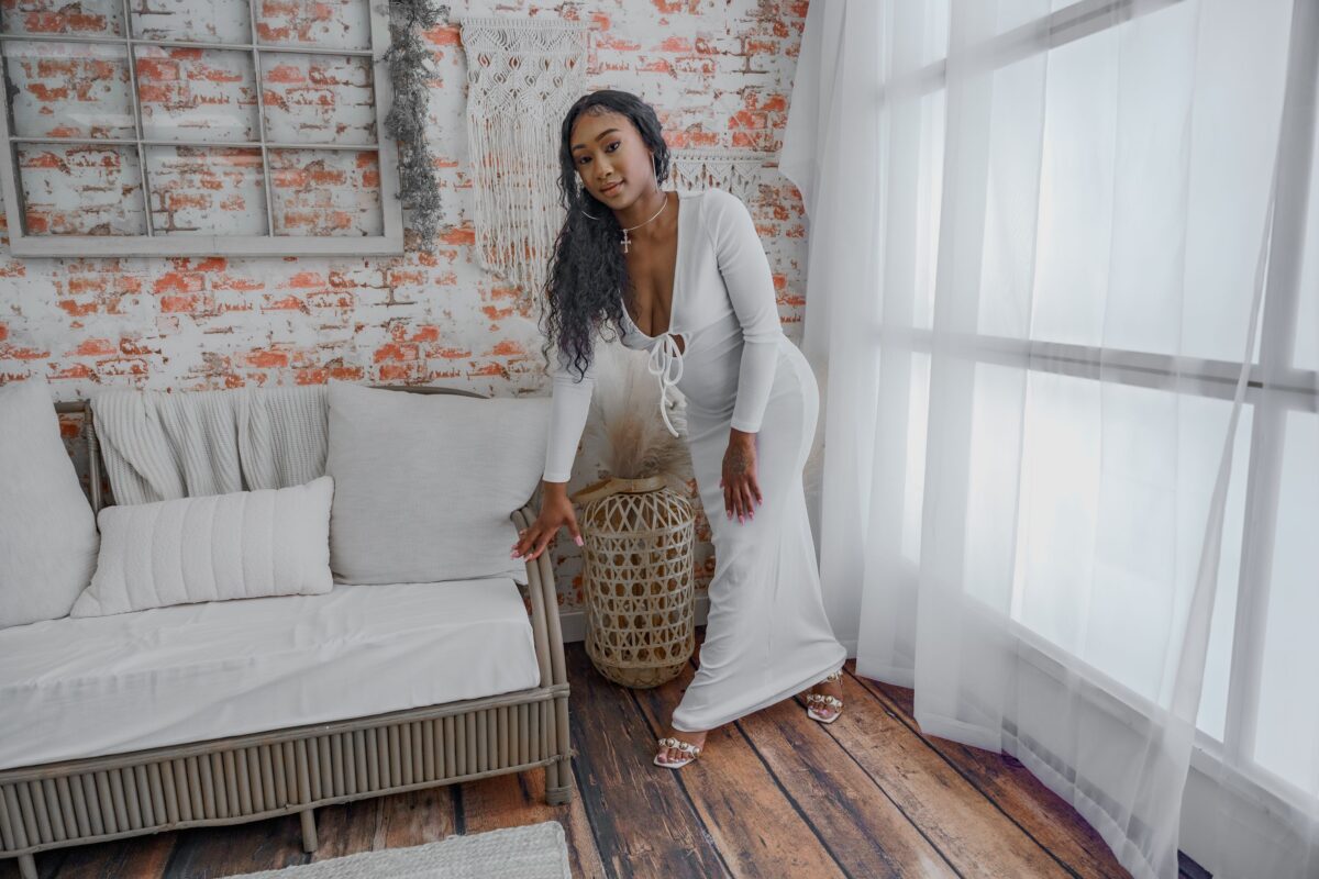 12 Outfits Women Wear That Men Notice More Than They Admit 5 a-woman-in-a-white-dress-posing-in-a-modern-room
