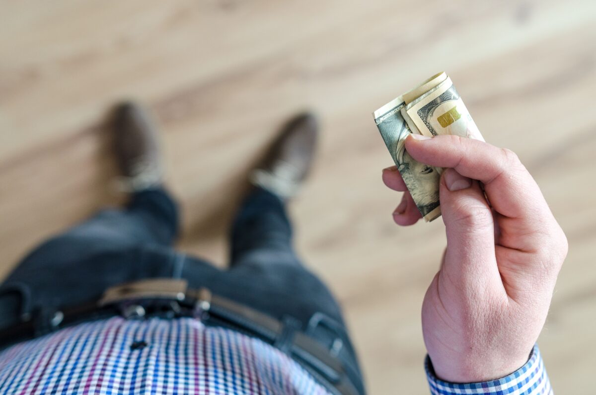 9 Financial Secrets That Can Break Trust Between Couples 5 person-holding-banknote