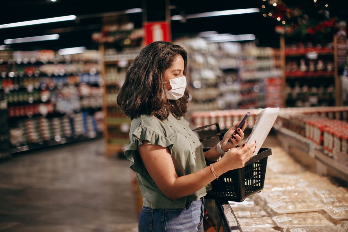 Dollar General Brings Back the $1 Deal as Shoppers Hunt for Relief From Rising Grocery Bills. 2 brunette-woman-in-face-mask-shopping-for-groceries-in-supermarket