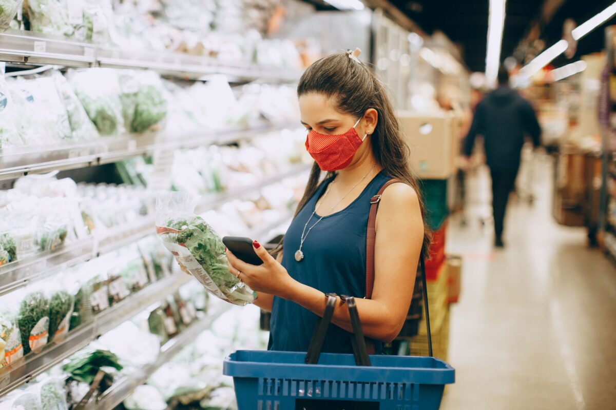 woman-looking-at-her-smart-phone-in-a-supermarket
