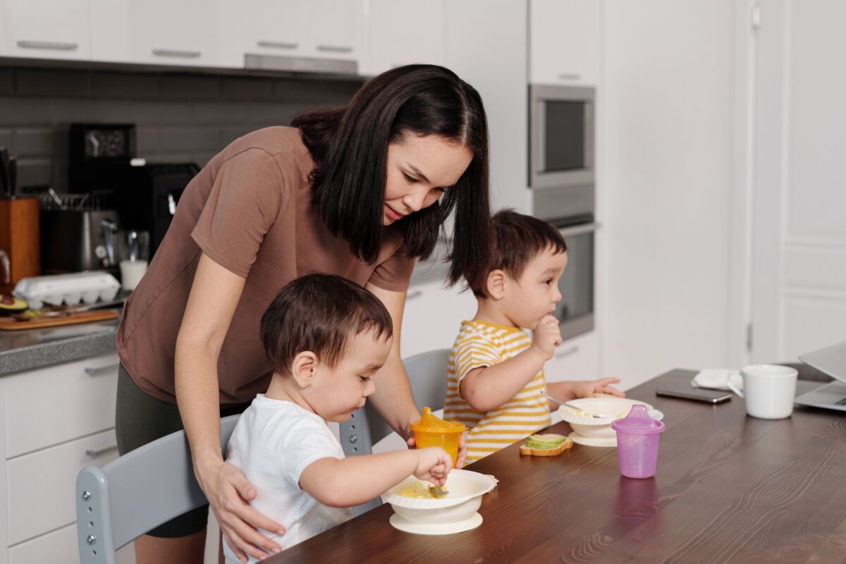 8 Parenting Challenges Every Modern Family Faces in the 21st Century 3 a-woman-in-brown-shirt-feeding-her-kids