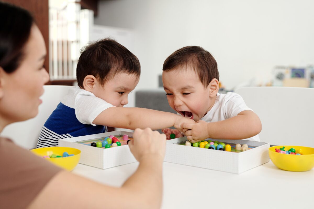one-little-boy-trying-to-bite-other-one-while-playing
