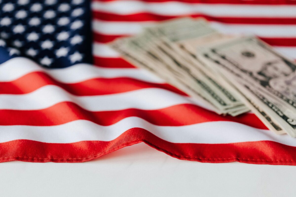 The American Pride Crisis Is No Longer Just Political Noise. 8 Reasons Why 4 american-dollars-on-national-flag