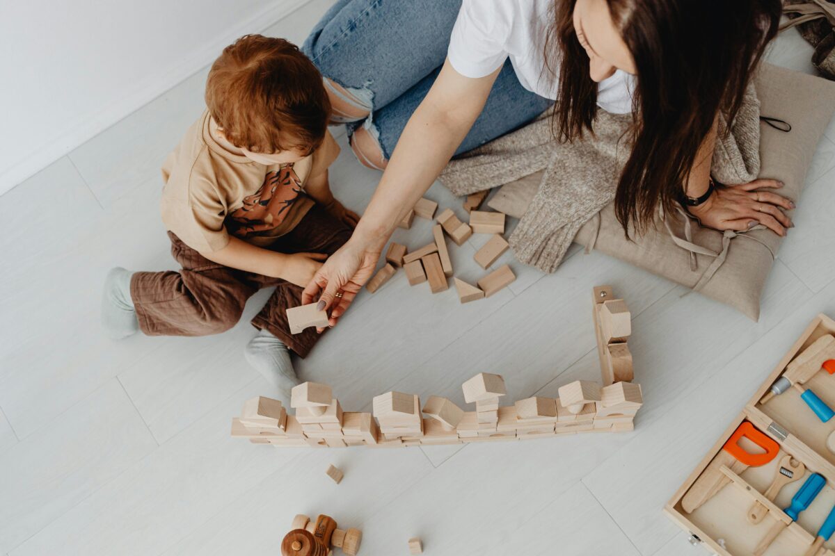 woman-playing-with-toy-blocks-with-son