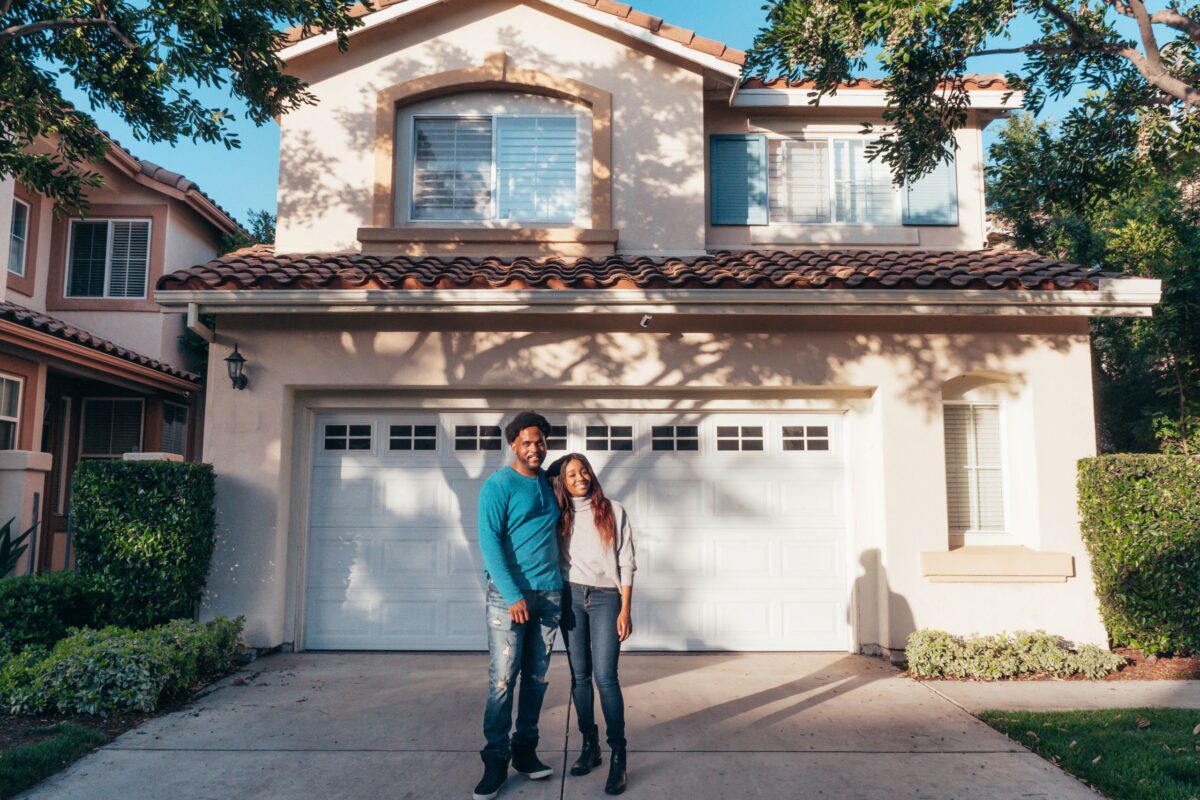 The Quiet Emotional Shift Happening Inside Modern Neighborhoods 2 couple-standing-in-front-of-their-house