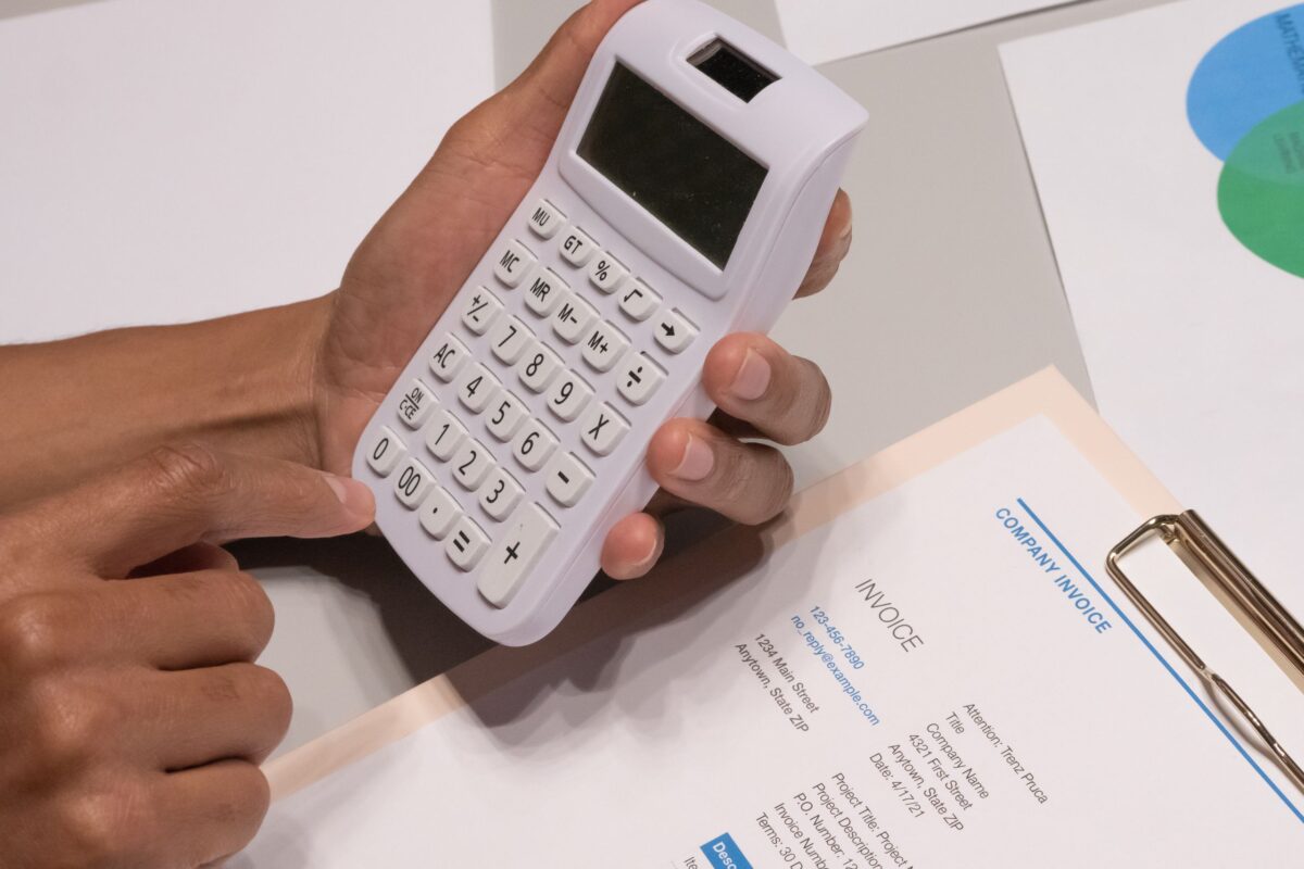 Hidden Fees Became America’s Second Price, And Shoppers Are Finally Pushing Back. 3 close-up-shot-of-a-person-using-calculator