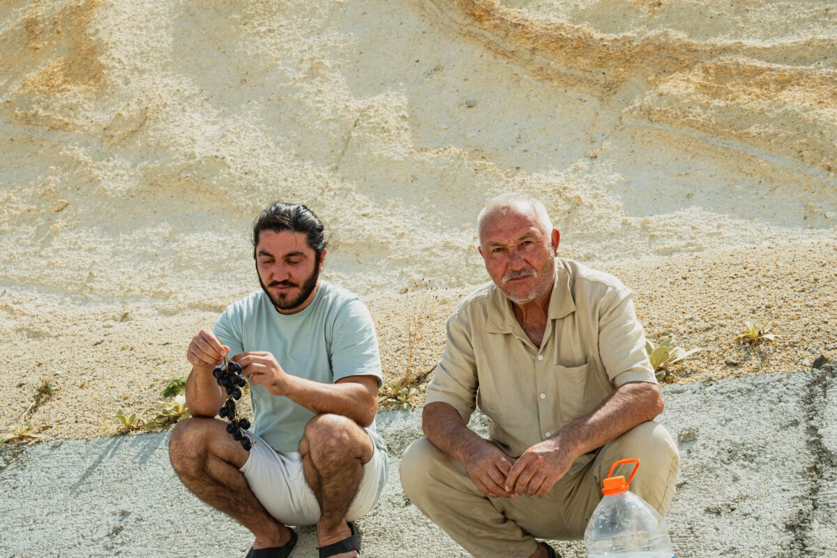 two-men-resting-by-desert-landscape