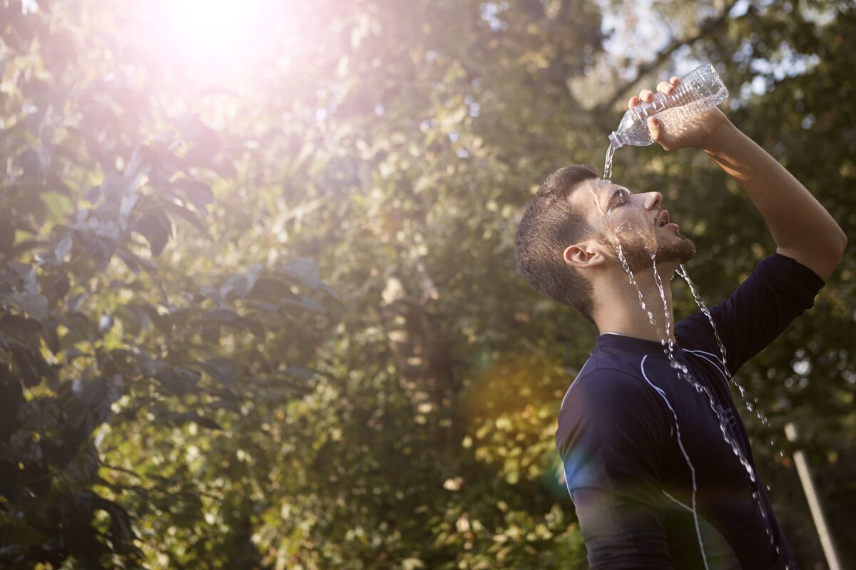 man-in-blue-crew-neck-t-shirt-while-pouring-water-on-his-face
