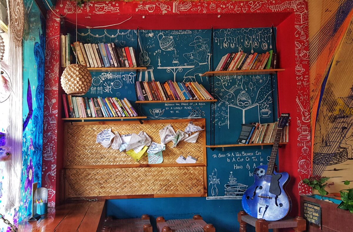 blue-jazz-guitar-beside-desk-books-on-shelves