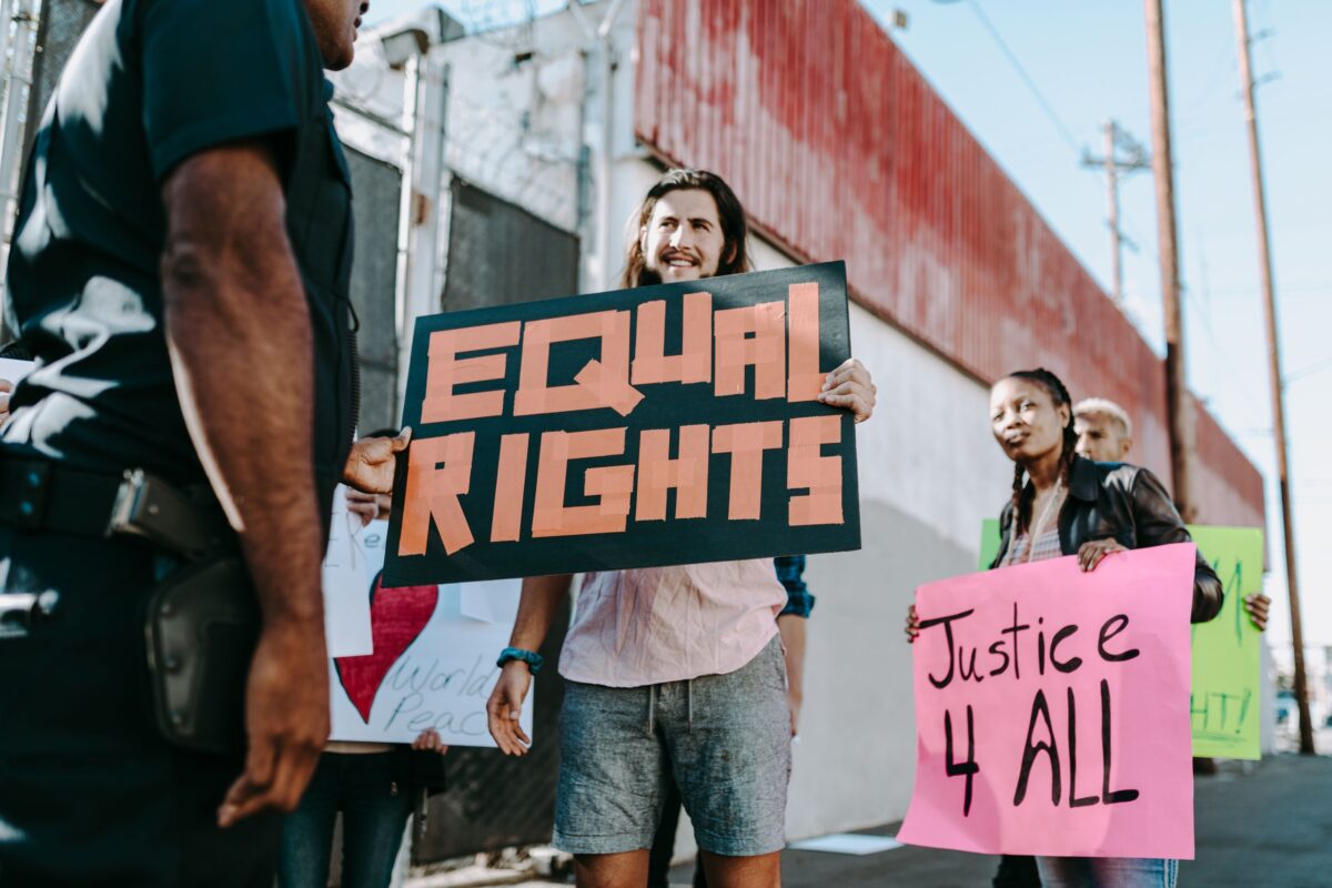 Supreme Court Upholds State Sports Bans on Transgender Women, and Schools Across America Are Now Facing a National Debate Over Fairness and Inclusion. 3 people-protesting-on-the-street