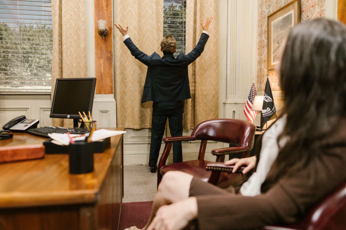 man-in-black-jacket-standing-near-brown-wooden-table