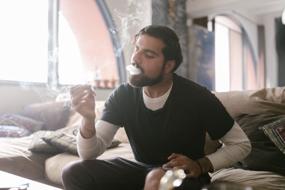 Texas Marijuana Gun Case Exposes a Legal Contradiction That America Still Hasn’t Resolved. 2 a-man-in-black-shirt-and-white-sweatshirt-smoking-weed