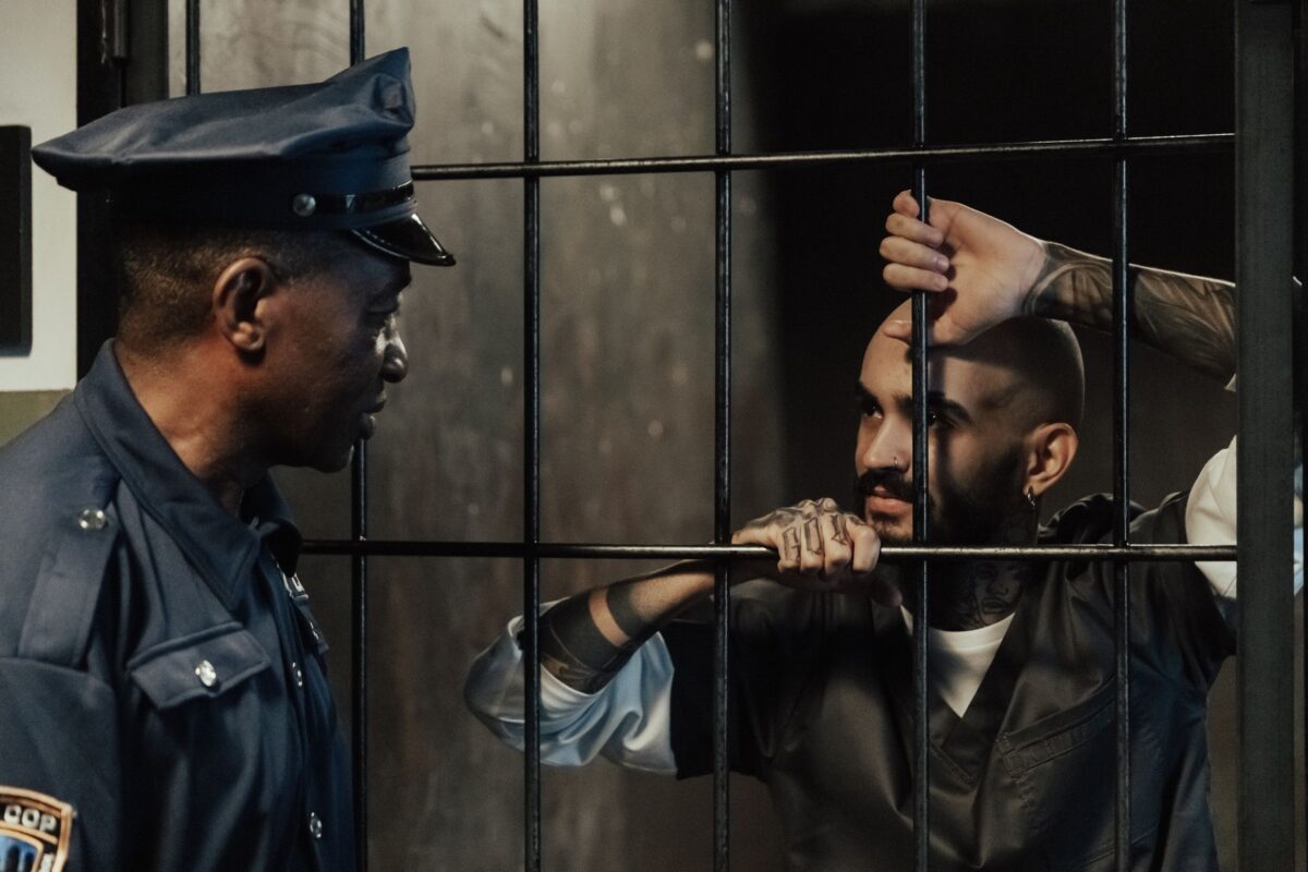 policeman-near-a-man-in-a-prison-cell