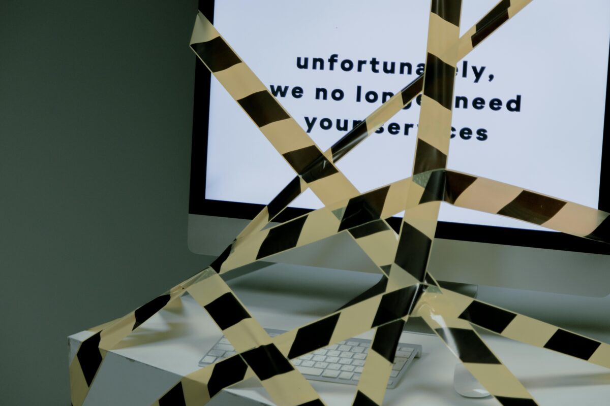 computer-tied-with-a-black-and-yellow-tape