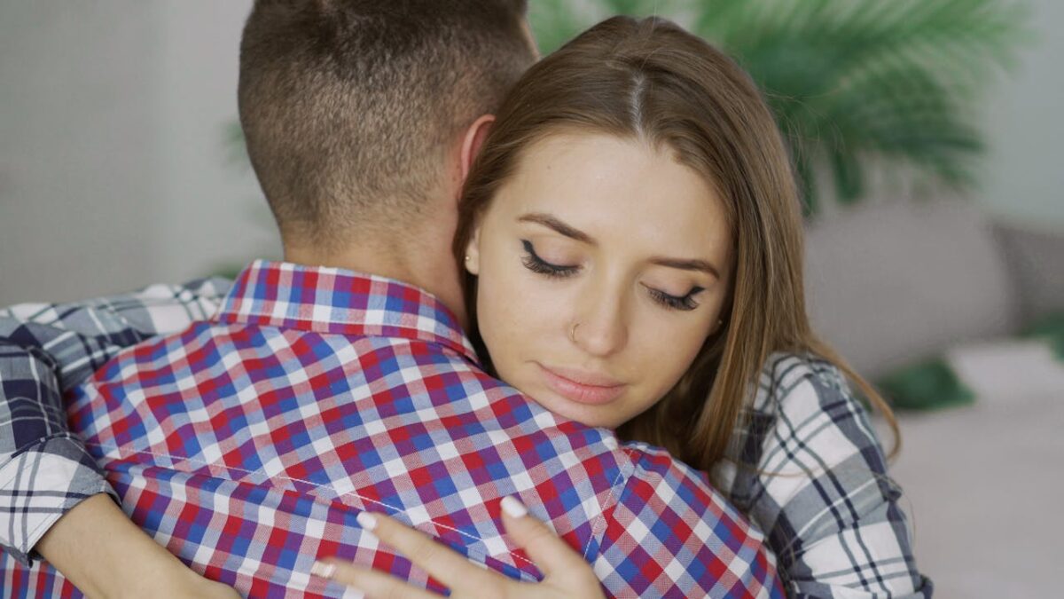 comforting-hug-between-young-couple-indoors-