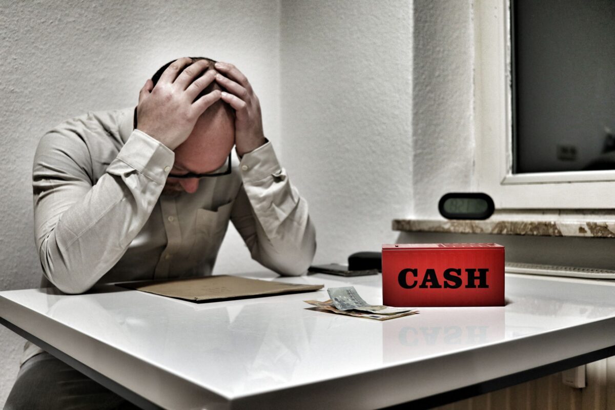 stressed-man-with-cash-box-in-office-setting