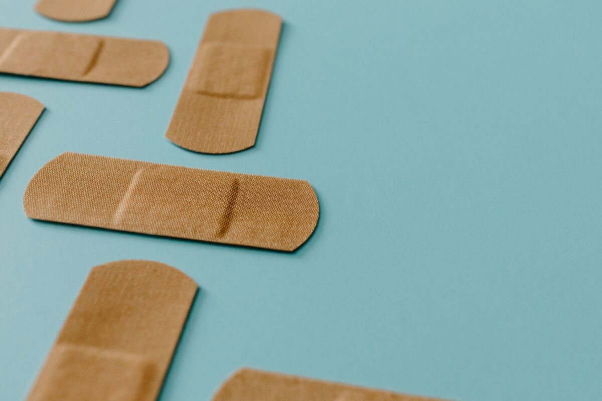 brown-band-aids-on-blue-surface
