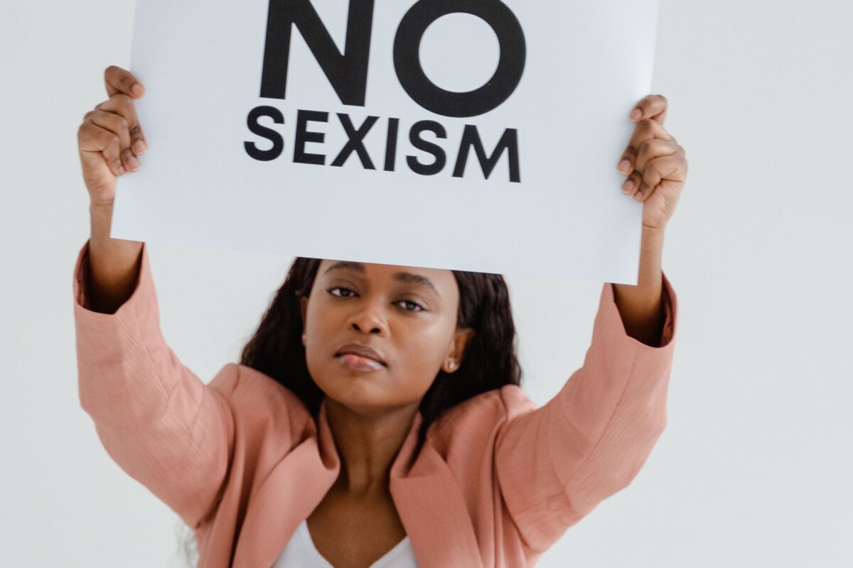 Supreme Court Upholds State Sports Bans on Transgender Women, and Schools Across America Are Now Facing a National Debate Over Fairness and Inclusion. 2 a-woman-holding-an-equality-poster