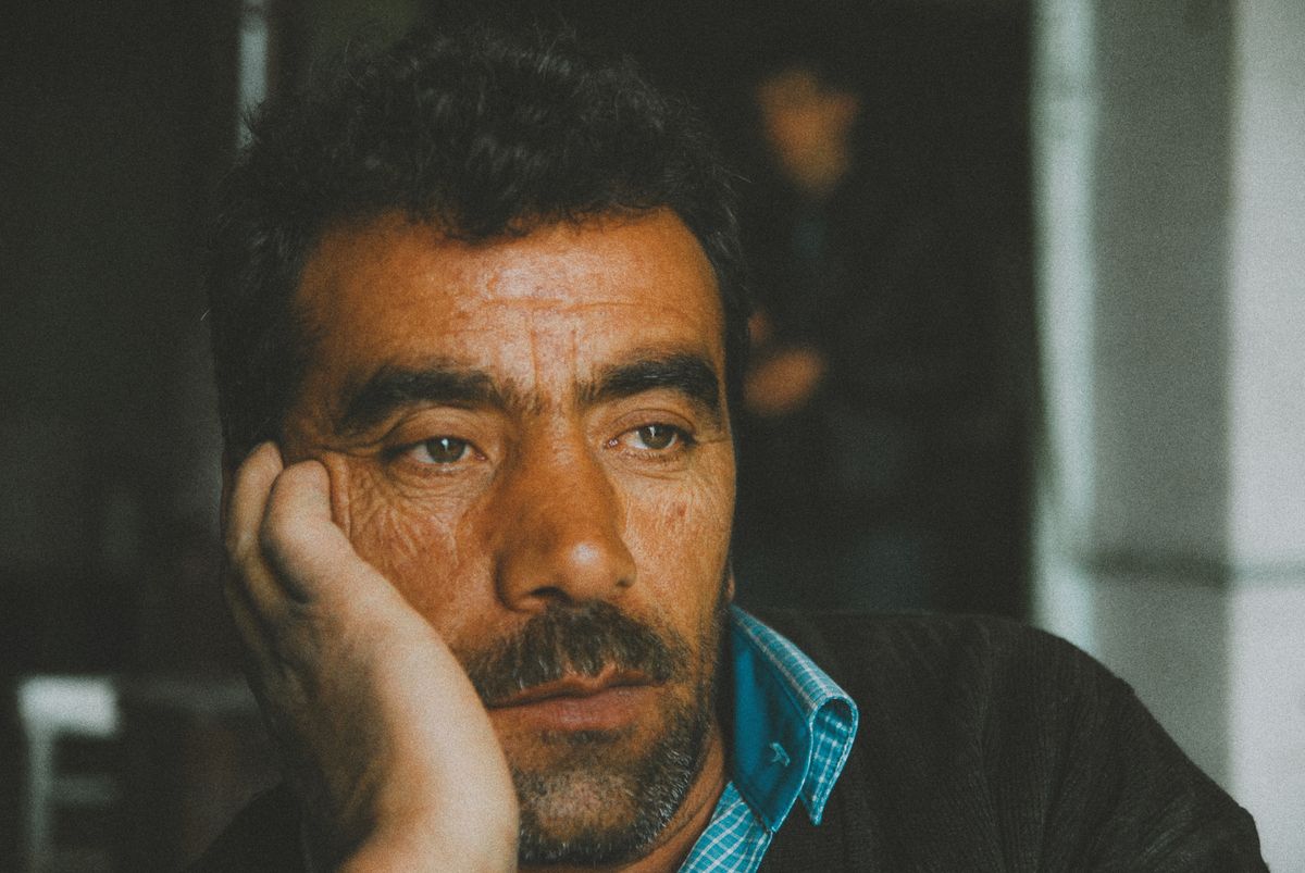 New Data Shows 8 States in the U.S. Where the Middle Class is Disappearing 1 Portrait of a contemplative man with a beard, mustache, and wrinkles, deep in thought, indoors.