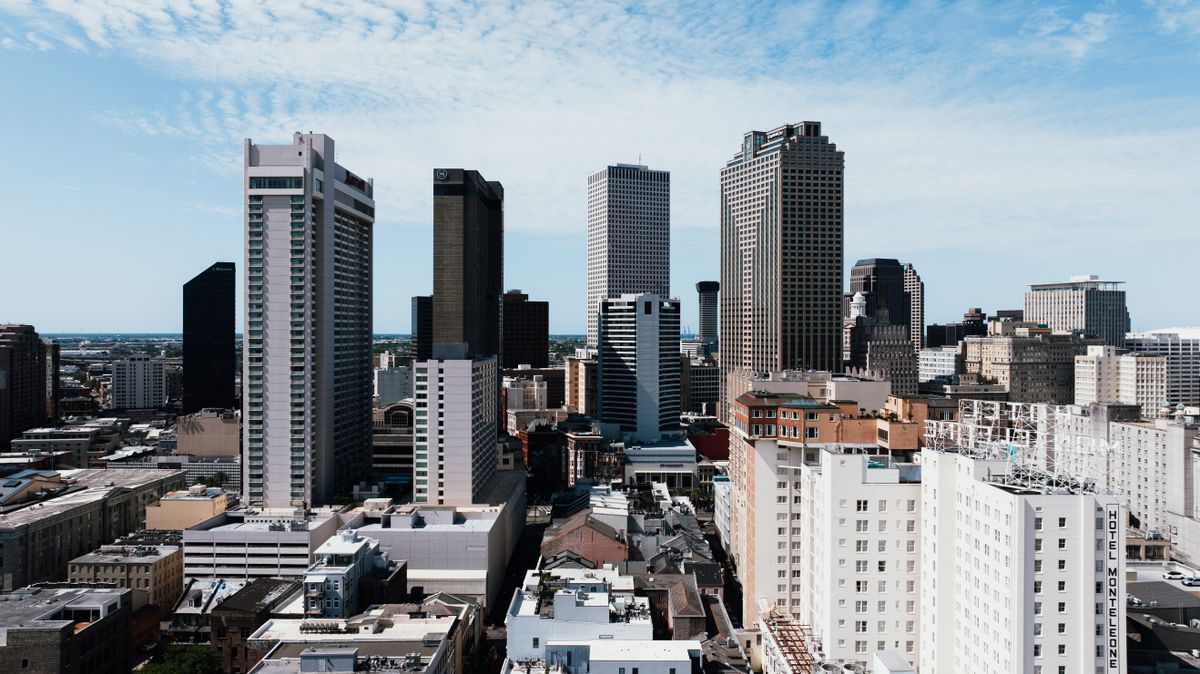 9 U.S. Cities Where Rising Heat Is Turning Daily Life Into a Nightmare 3 Skyline of downtown New Orleans showcasing skyscrapers under a clear blue sky.