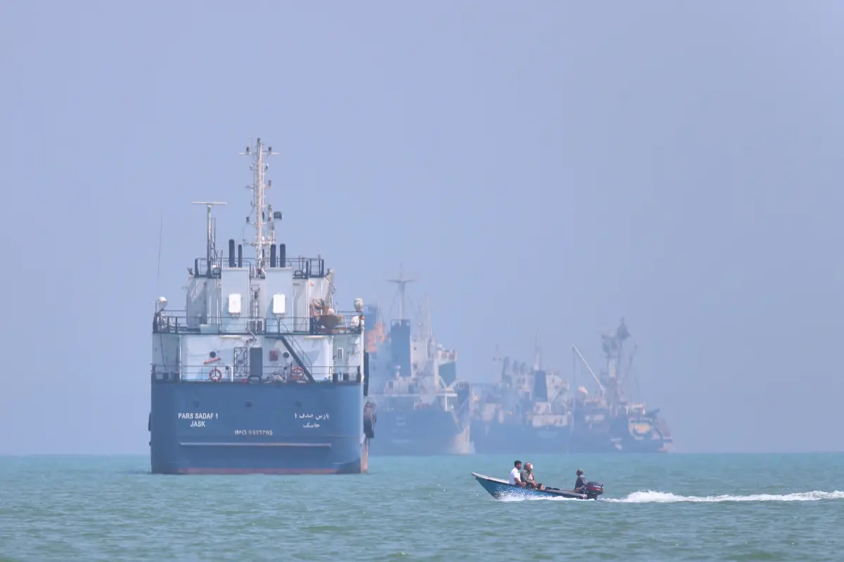 small motorboat passes anchored vessels 130573351 336d92