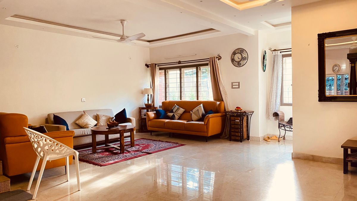 Spacious living room with stylish furniture and natural sunlight.
