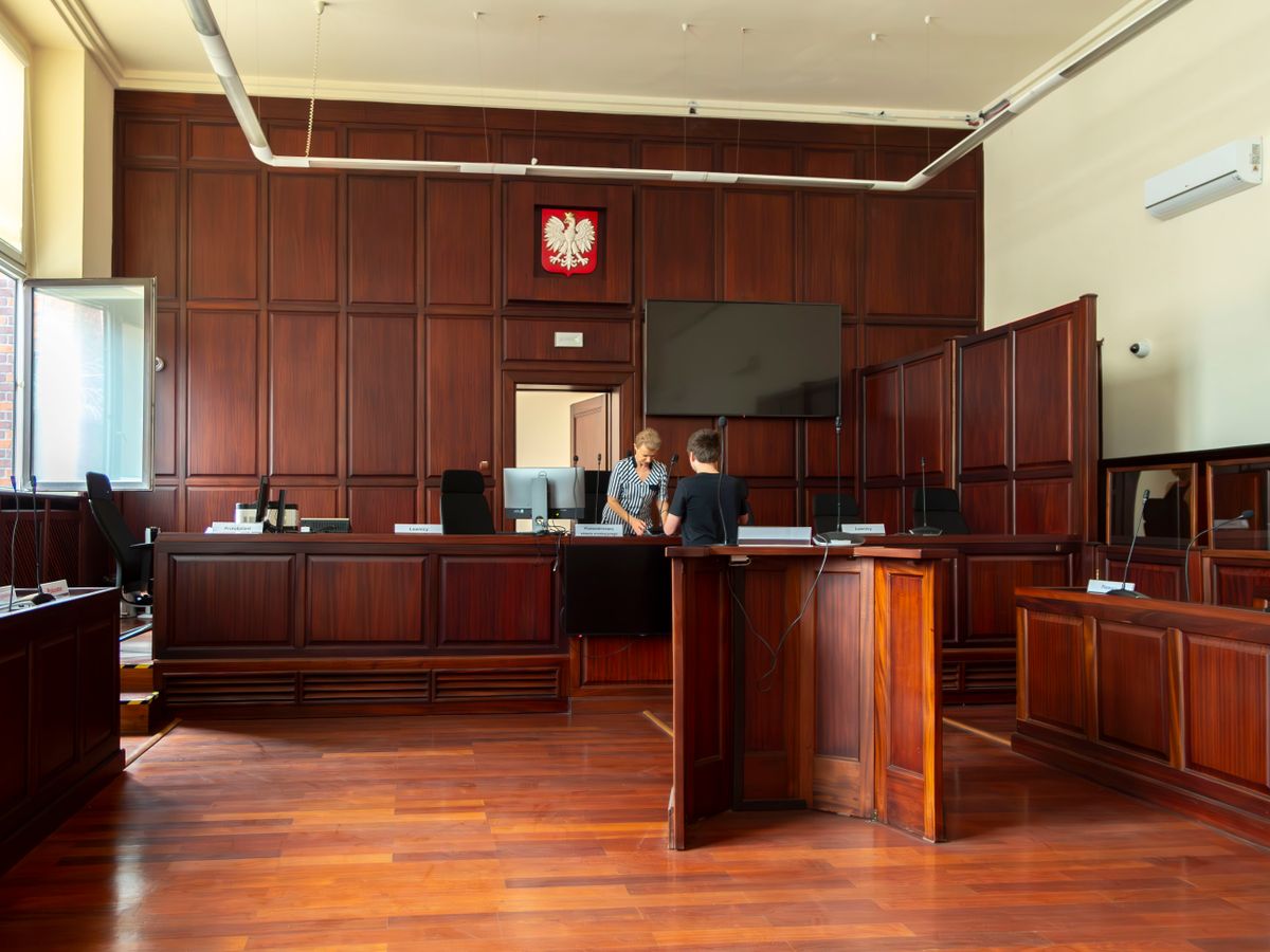 Spacious Polish courtroom with wooden panels and furniture located in Wrocław, Lower Silesia.