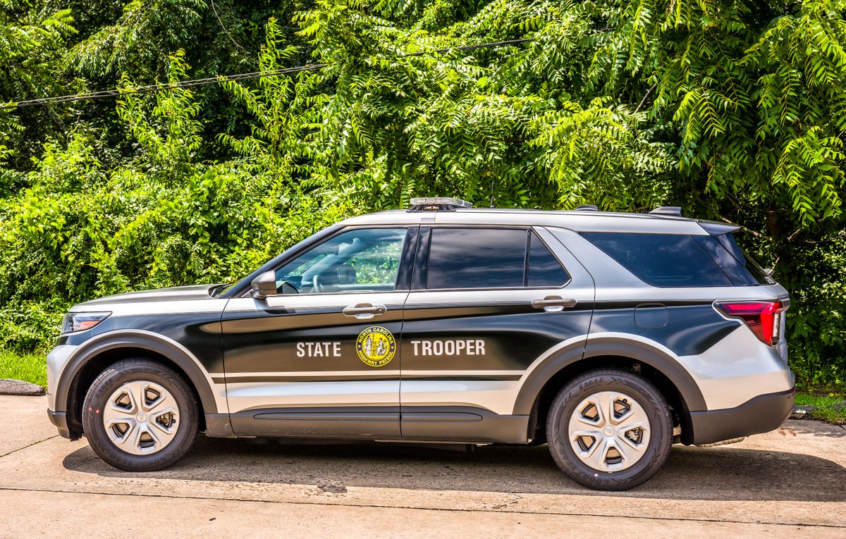 9 Reasons Florida’s ICE Surge Is Turning Routine Stops Into a Bigger Trust Fight 1 State trooper SUV parked on a sunny day with lush greenery in the background.