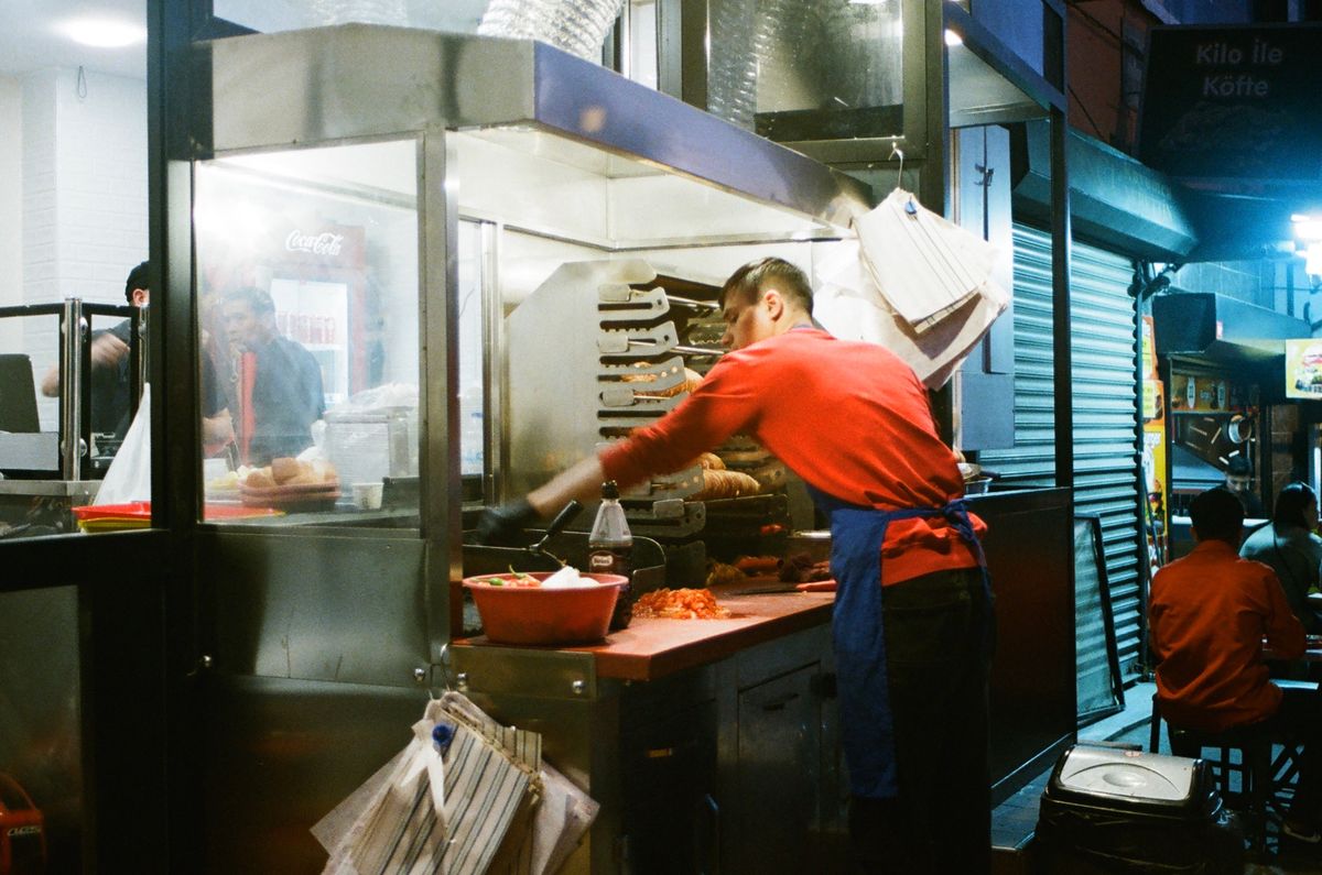 Terrifying McDonald’s Hot Oil Assault Raises Urgent Workplace Safety Questions 2 Street vendor preparing food at a night market, showcasing culinary skills in a lively stall.