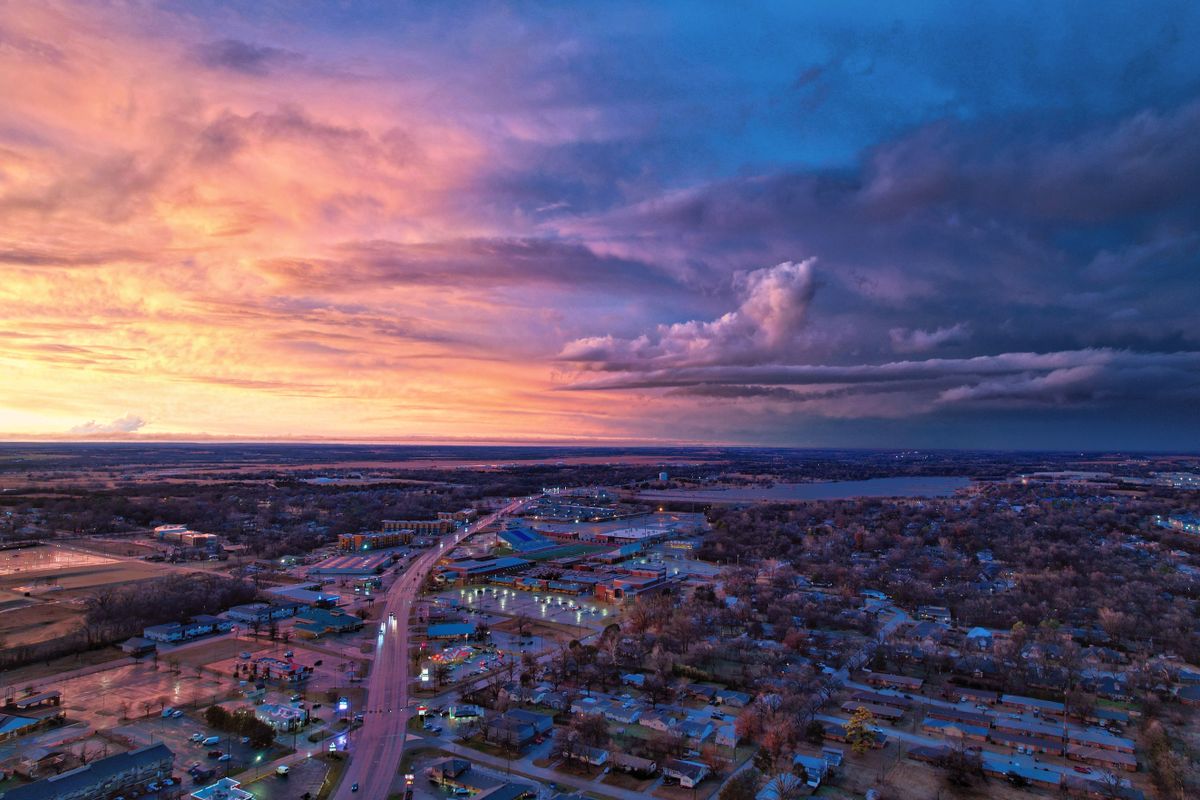 7 Most Miserable States to Live in America in 2026 2 Stunning aerial view of Stillwater, Oklahoma, showcasing vibrant skies at sunset with urban cityscape below.