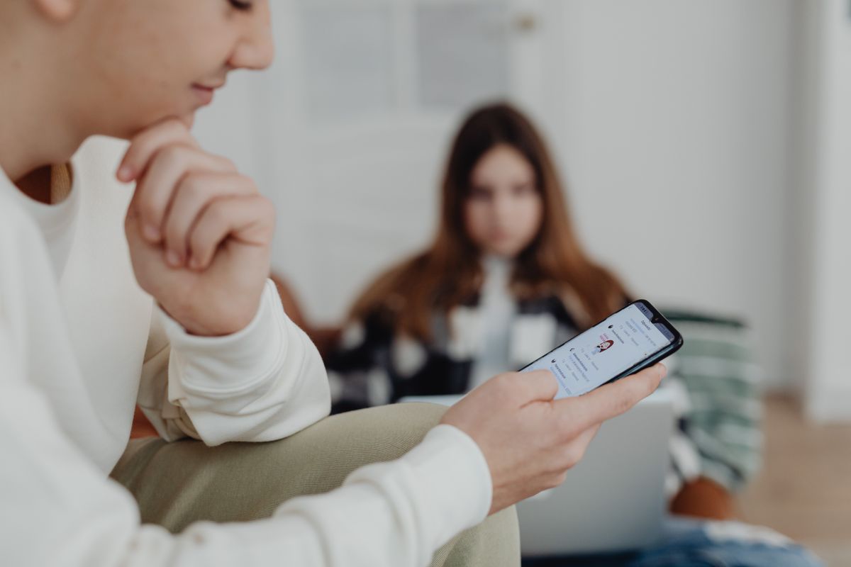 Michelle Obama Back in the Online Crossfire as Viral Claims Spark Fresh Debate Over America’s Digital Obsession With Public Figures 1 Teens using smartphones indoors with a blurred background, suggesting social media engagement.